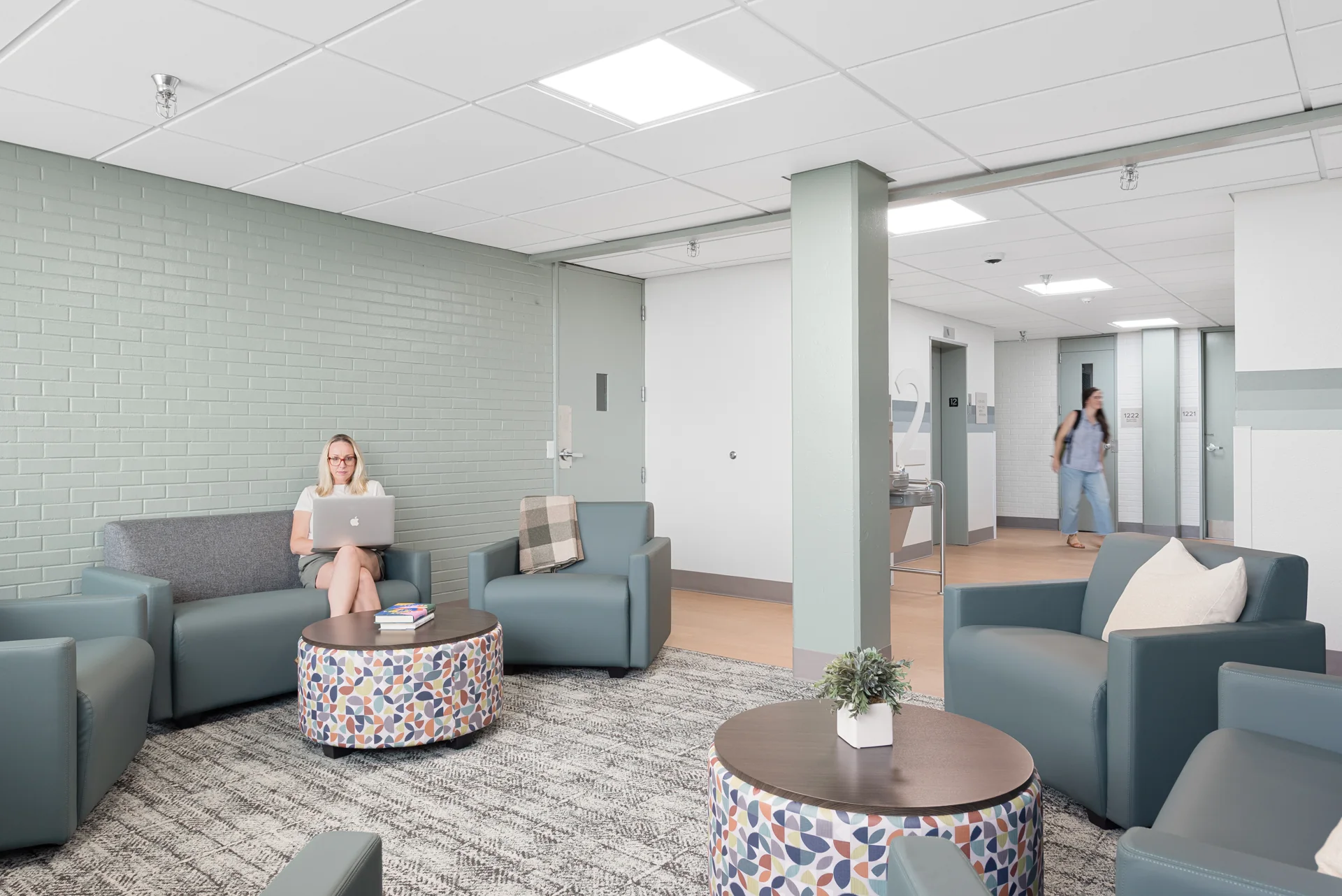 A shared lounge with a simple, welcoming palette.